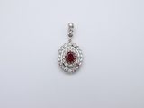 a ruby and diamond pendant on a white background