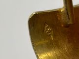 a close up of a gold plated object with a pair of scissors in it
