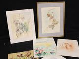several cards and a picture of a cat are on a table