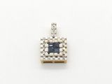 a close up of a blue and white diamond pendant on a white surface
