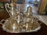 a silver tray with a silver tea set on it