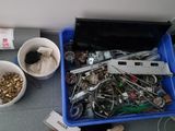 a blue container filled with assorted items on the floor