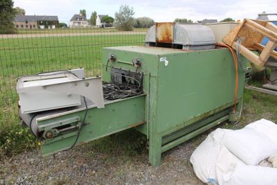 a green machine that is sitting in the grass