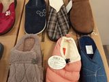 several pairs of slippers are lined up on a cardboard box