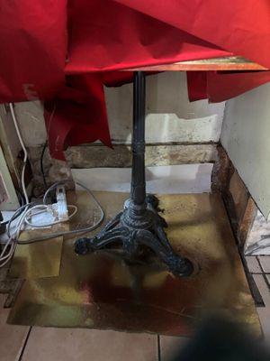 a small table with a red umbrella on top of it