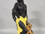 figurine of a woman with a basket of bananas