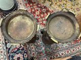 two pots sitting on a rug on the floor