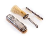 two brushes and a comb sitting on top of a white surface