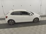 the white car is parked in the garage of the building