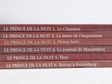books stacked on top of each other on a white surface