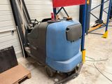 une machine bleue et noire qui se trouve dans un entrepôt