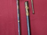two swords and a sword on a red cloth
