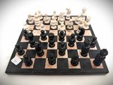 a black and white chess board with chess pieces on it