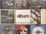 a lot of album covers on the wall of a room