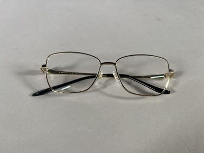 a close up of a pair of glasses on a white surface