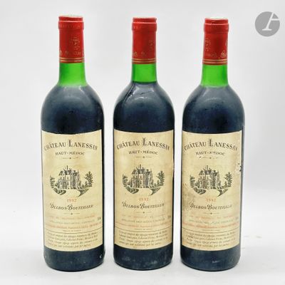 trois bouteilles de vin rouge posées l'une à côté de l'autre sur une surface blanche