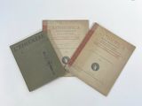 three books are sitting on a table with a white background