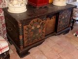 a wooden chest with a clock on top of it