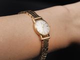 a woman that is wearing a watch on her wrist