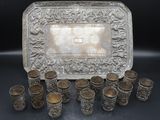 a silver tray with cups and a tray of silver cups