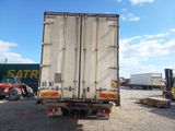 a truck that is parked in a lot with other trucks