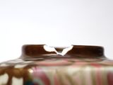 a close up of a vase on a table
