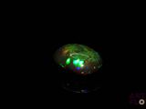 an image of a green light in the dark with a black background