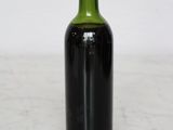 a bottle of wine sitting on a counter top