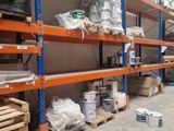many shelves in the warehouse with many items on them