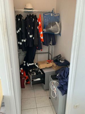 a closet with a lot of clothes and other items