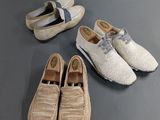 three pairs of shoes and a pair of shoes on a table