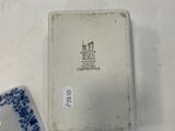 a small blue and white plate and a small blue and white plate on a white table