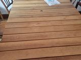 a wooden table with chairs around it in a room