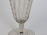 a clear glass wine glass on a white surface