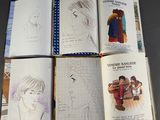 several pages of children ' s drawings are spread out on a table