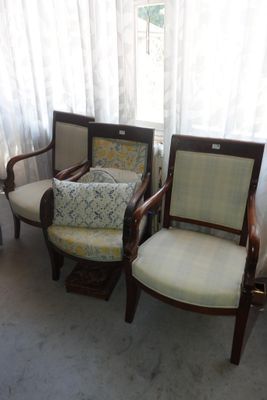 three chairs that are sitting next to each other in a room