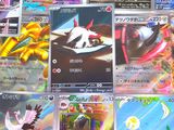 a lot of pokemon cards that are on the table