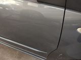 a close up of a car door handle with a sticker on it