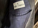 an image of a suit with a label on it sitting on a chair