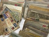 a pile of old letters and envelopes sitting on a table