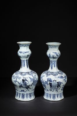 pair of blue and white vases on a black background