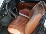 a brown leather seat in the back of a car
