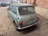 a small car that is parked on the side of the street