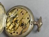 someone is holding a pocket watch with a chain attached to it