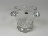 a glass vase with a handle on a white table