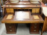 a wooden desk with a marble top in a room