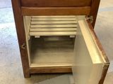 a small wooden cabinet with a sink inside of it