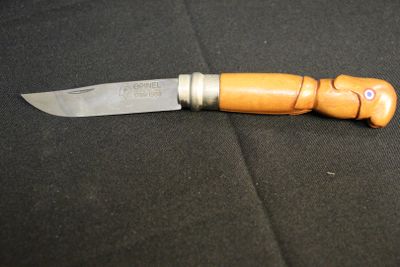 a knife with a wooden handle on a black surface