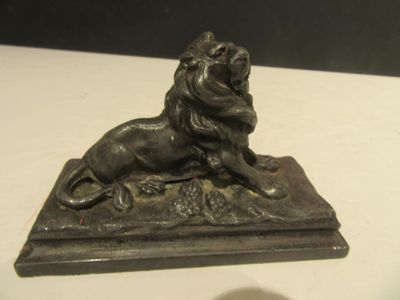 a statue of a lion sitting on a table