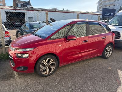 the red car is parked in the parking lot next to other cars